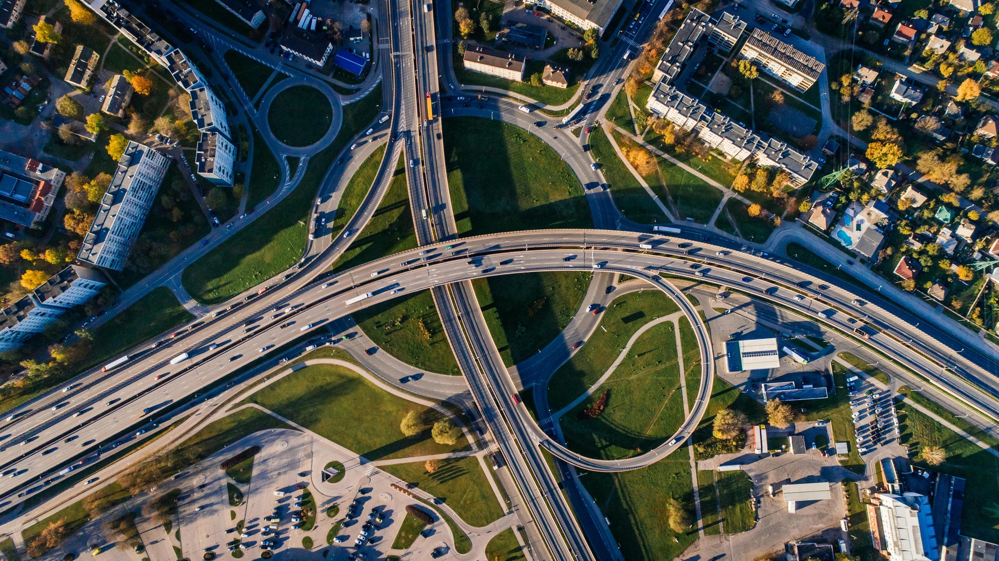 Bird’s eye view of a motorway featuring large circular exits and entry ramps
