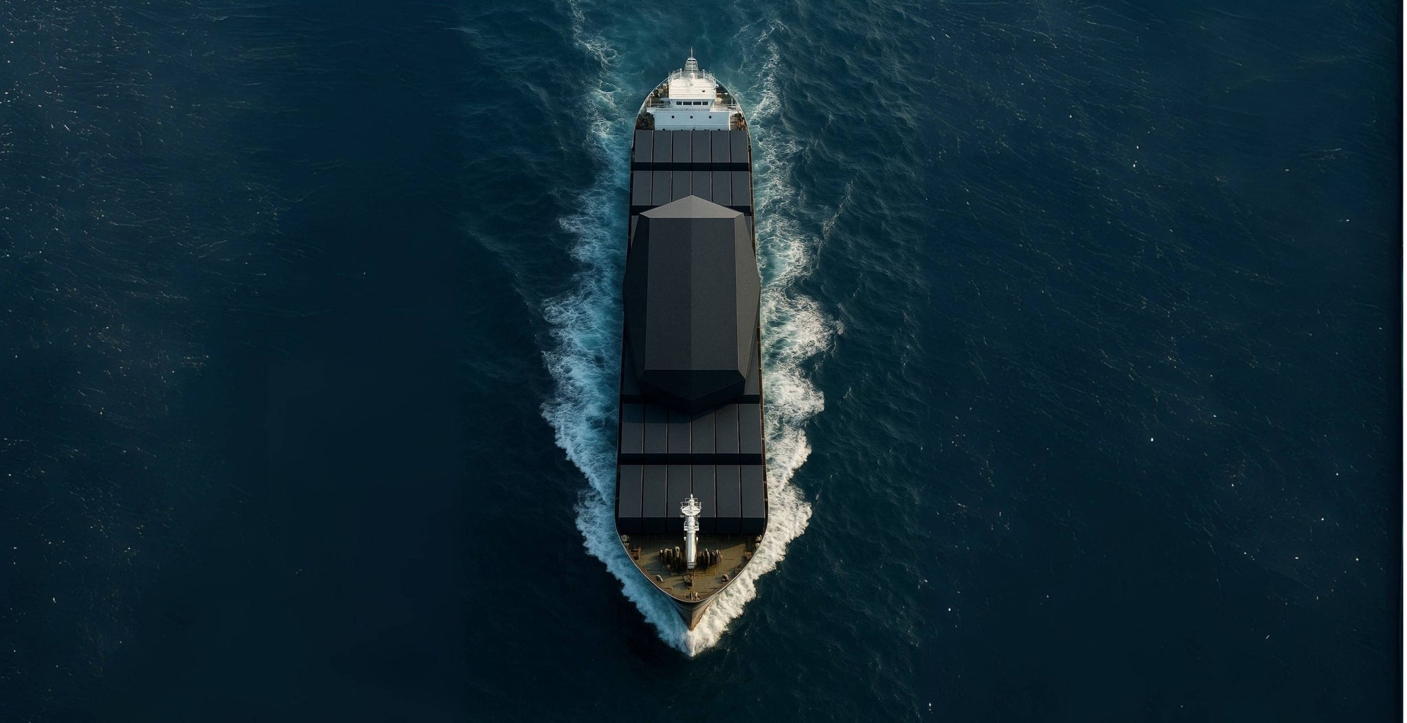 Boat traveling on a body of water from an aerial perspective