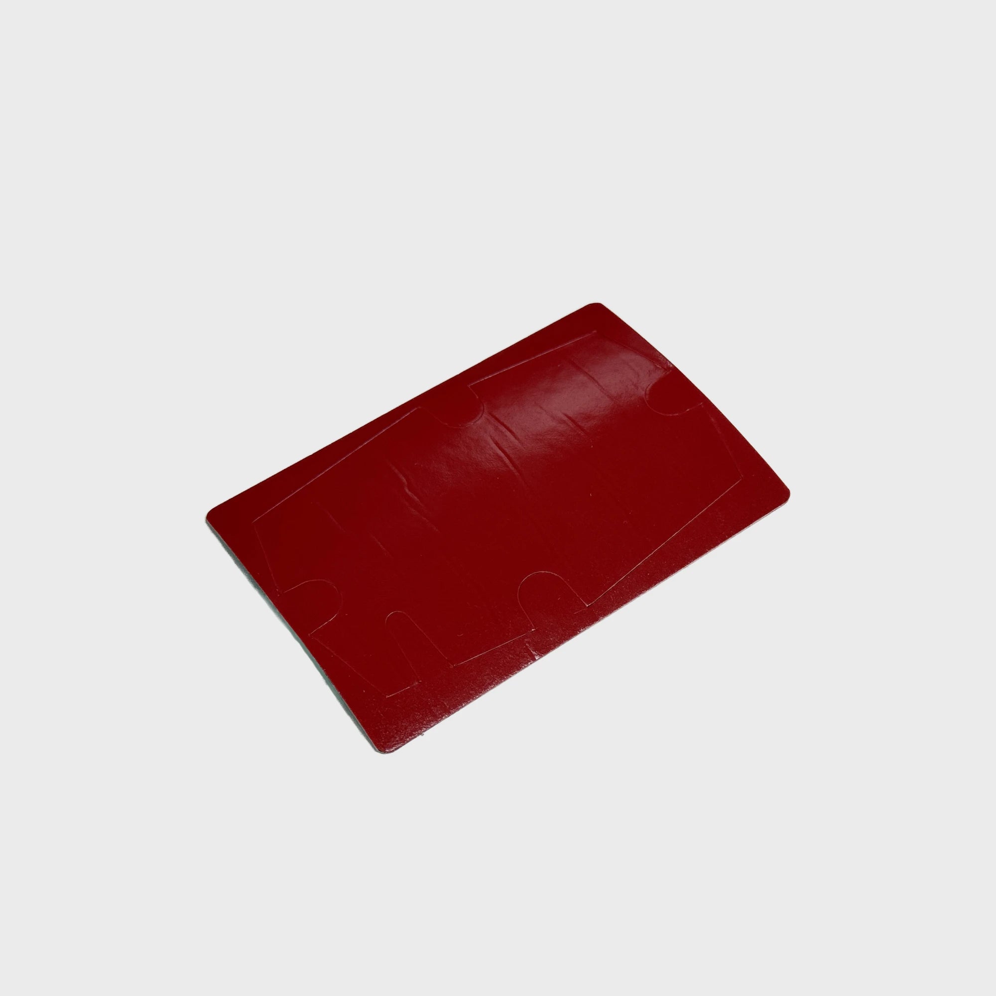 Close-up of a glossy red foam tape fitting the Gemstone GPS tracker 
